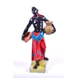 A 20th century plaster Blackamoor figure formed as a man carrying a vase and a bowl, supported on