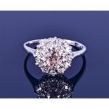 An 18ct white gold, platinum, and diamond cluster ring set with an old mixed-cut pink diamond of