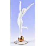 A German Hutschenreuther porcelain figure of a nude woman stood on one foot on a golden orb with