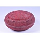 A late Qing period Chinese cinnabar lacquer box of circular form the cover decorated with a