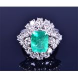 A diamond and emerald cocktail ring set with an emerald-cut emerald, approximately 10 x 8 mm,