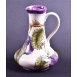 A Cobridge Stoneware pitcher in the Plum pattern designed by Nicola Slaney, dated 1998, 18 cm high.