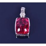 An 18ct white gold, diamond, and pink tourmaline pendant set with a cabochon tourmaline, of