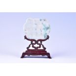 A late 19th / early 20th century Chinese carved jade plaque with incised calligraphic detail, on a