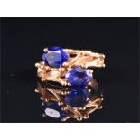 An unusual 14K yellow gold and amethyst ring the naturalistic mount set with two oval-cut amethysts,