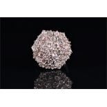 A diamond cluster ring composed of four tiers of graduated round brilliant-cut set diamonds weighing