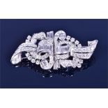 A platinum (tested) and diamond double clip brooch the stylised scrolled mount set with round and