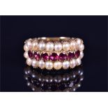 A late 19th / early 20th century yellow gold, pearl, and garnet ring set with a row of