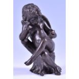 A 19th century small bronze model of a cherub seated on a tree stump reading a book. 14.5 cm high.