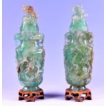 A large pair of Chinese fluorite vases and covers deeply carved with flowers and branches, and