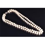 A double strand cultured pearl necklace fastened with a 9ct white gold and diamond clasp.