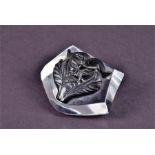 A Lalique crystal paperweight  decorated with a black glass stylised grotesque mask on a clear
