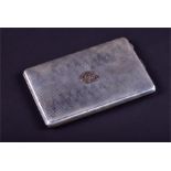 An early 20th century white metal cigarette case of rectangular form, relief gilt monogram to cover,