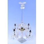 An early 20th century clear cut glass four branch table lamp the tapering central stem on a
