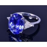 An 18ct white gold, diamond and sapphire ring set with an oval-cut natural Ceylon sapphire of