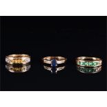 A 14ct yellow gold and emerald band ring inset with five round-cut emeralds, size T 1/2, together