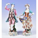 A pair of 19th century porcelain figures of a gallant and a lady dressed in brightly-coloured