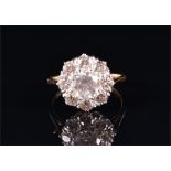 An 18ct yellow gold and diamond cluster ring centred with a round brilliant-cut diamond surrounded