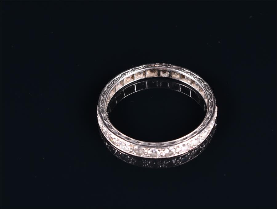 A diamond eternity ring set in unmarked white metal, set with twenty-five old round cut diamonds, - Image 2 of 2