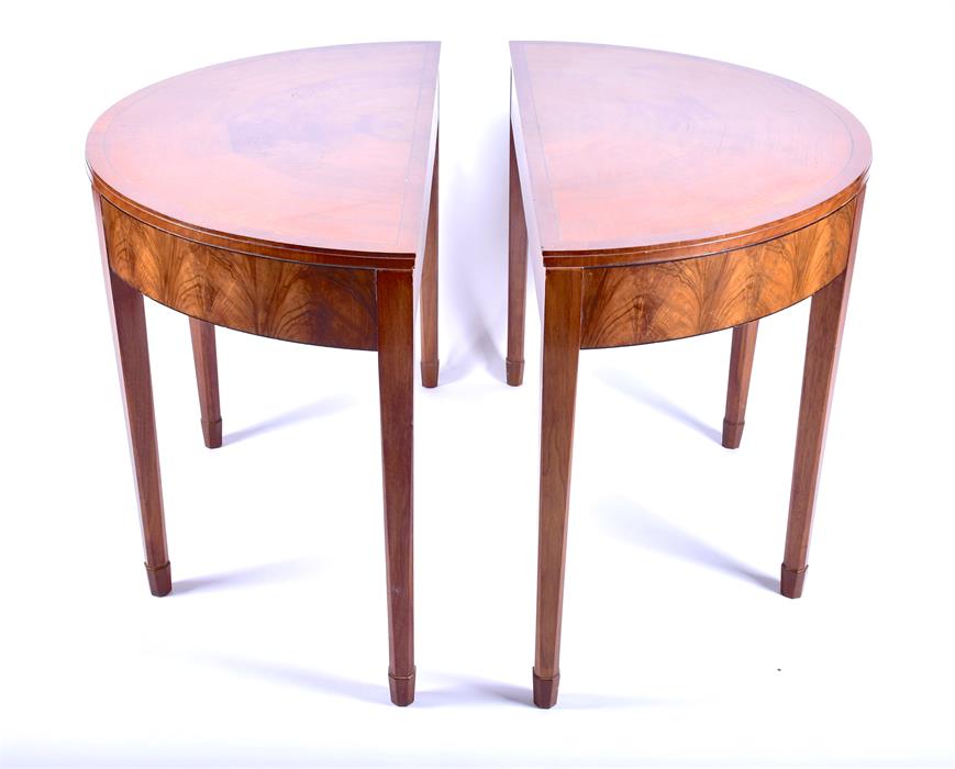 A pair of Heals walnut demilune tables originally part of a dining table, with segmented veneered