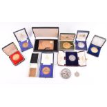 A collection of mid 20th century commemorative medallions all in fitted boxes.