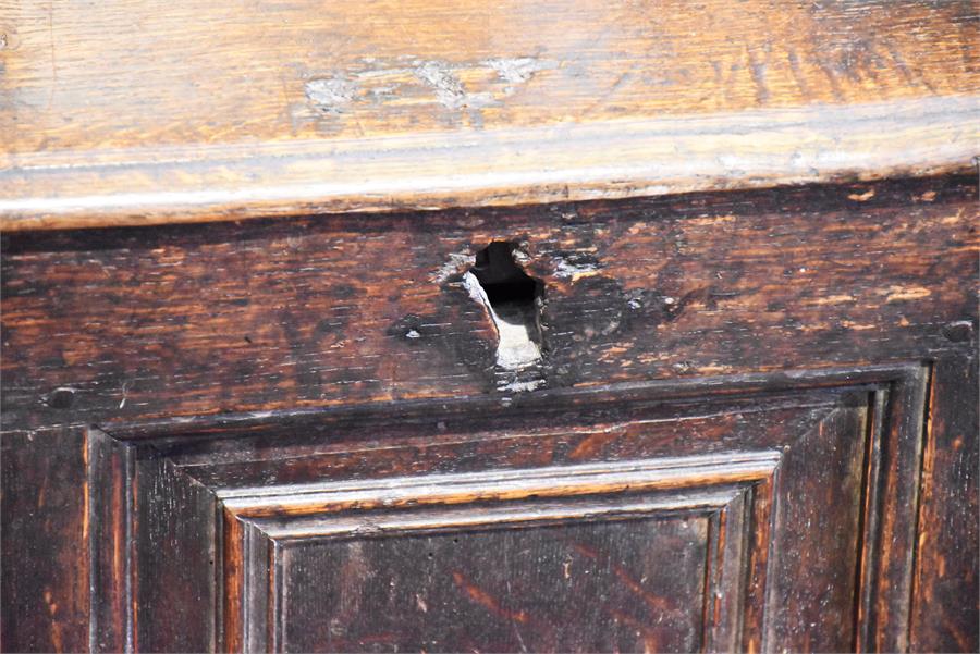 An 18th century oak panelled coffer with twin plank top and a triple panelled front. 104 cm wide. - Image 2 of 4