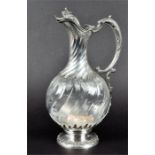 A 19th century French silver mounted rock crystal wine jug with wryten neck and cut bowl on a shaped