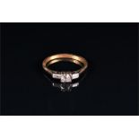 A diamond ring centred with a round brilliant-cut diamond weighing approximately 0.32 carats,