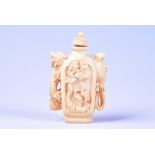 A late 19th / early 20th century Chinese carved ivory snuff bottle decorated with vignettes of