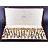A Continental silver handled set of 12 dessert knives and forks with repousse .800 silver handles,