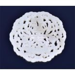 A late 19th / early 20th century Chinese carved jade plaque or medallion of symmetrical circular