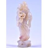 A 20th century Chinese carved jadeite figure group a lady carries a child upon her back who