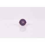 An Egyptian gold and Alexandrite ring set with a circular stone, approximately 14mm diameter,