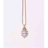 A 9ct yellow gold and diamond cluster pendant of oval form, set with a marquise-cut diamond