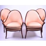 A set of four reproduction mahogany cream-upholstered cushioned armchairs with curved back, on