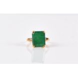 An 18ct yellow gold, diamond, and emerald ring set with an emerald cut emerald, 12 x 10 mm, the