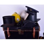 A cased collection of assorted hats  including a safari hat, a fireman's hat, two Chinese hats, a
