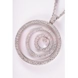 Chopard. An 18ct white gold and diamond 'Happy Diamond' pendant of circular form, the glass circle