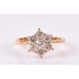 An 18ct yellow gold and diamond daisy cluster ring set with seven round-cut stones, size N 1/2, 3.