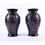 A pair of Japanese Meiji period bronze vases the ovoid shaped vases decorated with relief birds