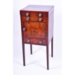 A George III mahogany washstand rising top with circular cut outs and flamed covered door, single