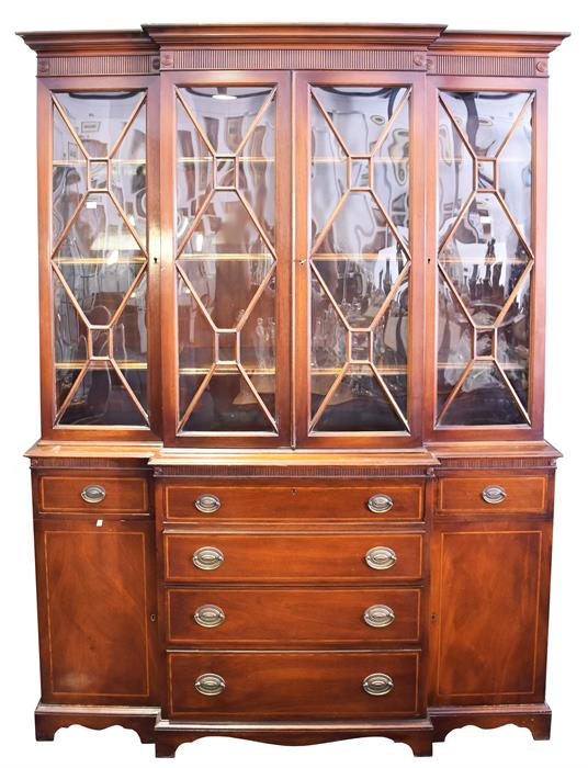 A large good quality mahogany breakfront secretaire bookcase the glazed panelled doors above a