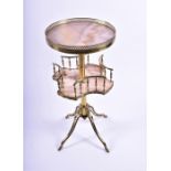 An Edwardian two-tier waiter / whatnot in polished onyx on a brass frame, each tier with pierced and