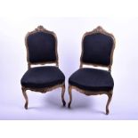 A pair of late 19th / early 20th century French chairs with upholstered seats and backs, carved