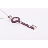 Theo Fennell. An 18ct white gold 'devil key' pendant pave-set with rubies, with horns and forked