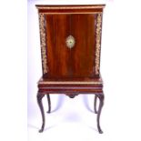 A 19th century rosewood and parcel gilt cabinet on stand the cabinet decorated with well carved