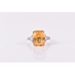 An 18ct white gold, diamond, and yellow sapphire ring set with a faceted rectangular-cut natural