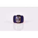 A yellow metal, blue enamel, and sapphire ring set with a natural colour-change sapphire,