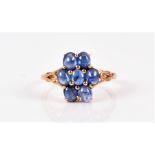 A 9ct yellow gold and sapphire floral cluster ring set with seven oval cabochon sapphires, cluster