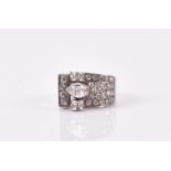 An Art Deco style diamond ring the white metal asymmetric mount set with a pear-cut diamond of